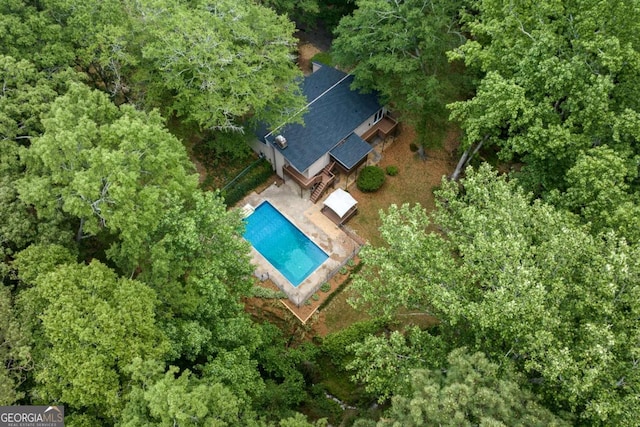 aerial view of property and surrounding area with a pool