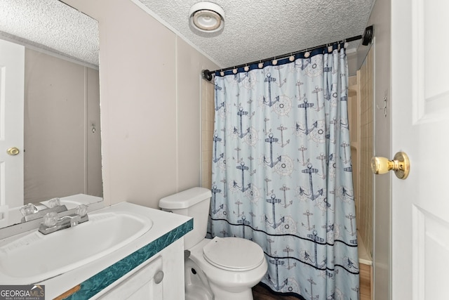 bathroom featuring a textured ceiling, a shower with shower curtain, toilet, and vanity