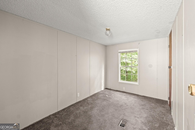 unfurnished bedroom featuring carpet floors and a textured ceiling