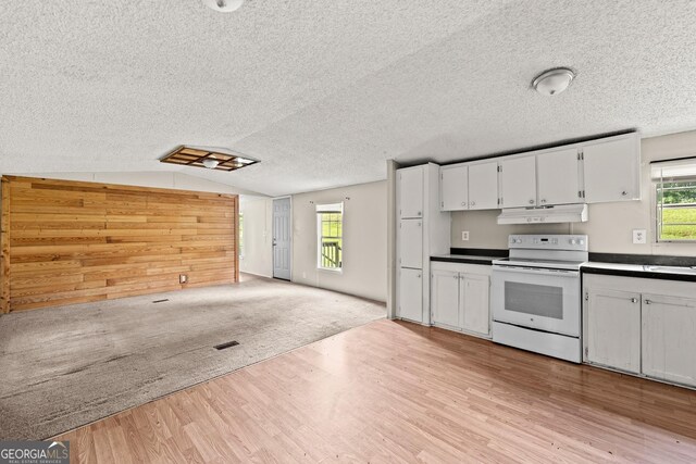 kitchen featuring white range with electric cooktop, under cabinet range hood, light wood-style flooring, open floor plan, and lofted ceiling