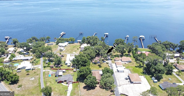 aerial overview of property's location with a nearby body of water and nearby suburban area