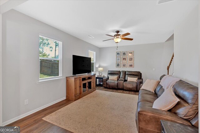 48 Sweetgum Trce, Dallas, GA 30132 - living area featuring wood finished floors, baseboards, a ceiling fan, and stairway