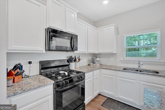 48 Sweetgum Trce, Dallas, GA 30132 - kitchen featuring black appliances, a sink, white cabinets, light stone countertops, and recessed lighting
