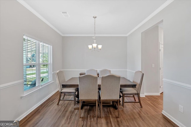 48 Sweetgum Trce, Dallas, GA 30132 - dining area featuring wood finished floors, a chandelier, baseboards, and crown molding