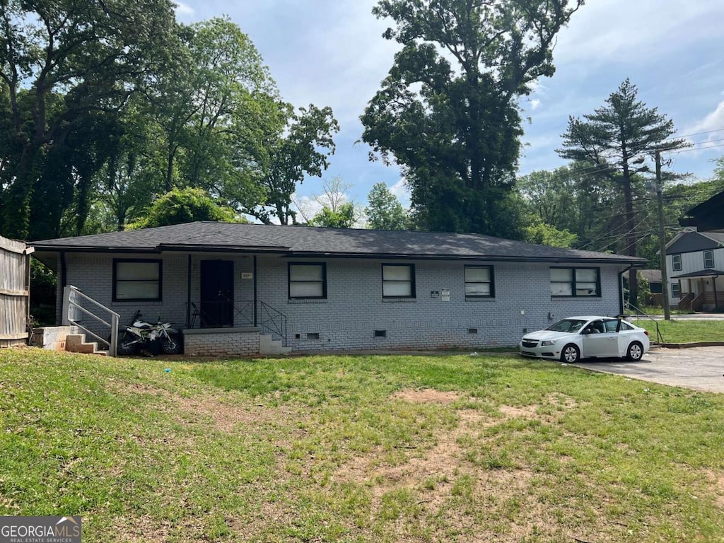 single story home featuring crawl space, brick siding, and a front yard