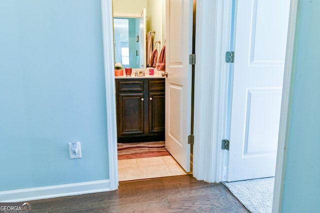 hall with wood finished floors and baseboards