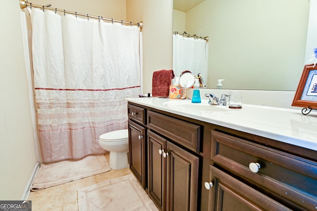 full bath featuring toilet, vanity, and tile patterned floors