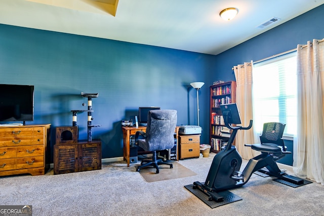 carpeted office space featuring baseboards