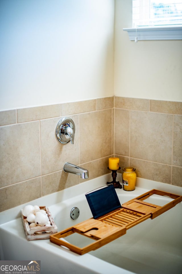bathroom with a tub to relax in