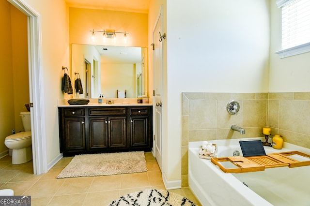 bathroom with tile patterned flooring, toilet, a garden tub, and vanity