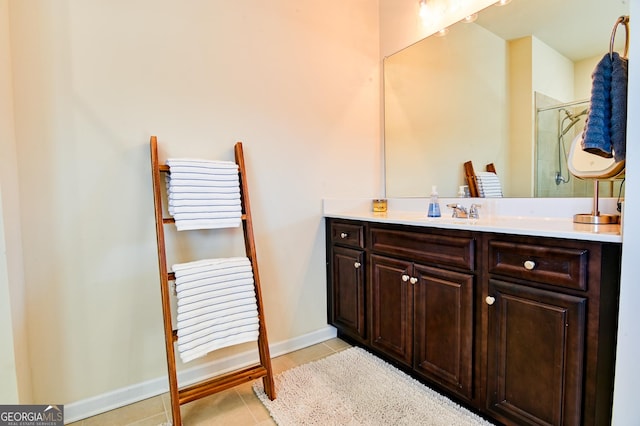 bathroom featuring tile patterned floors, an enclosed shower, vanity, and baseboards
