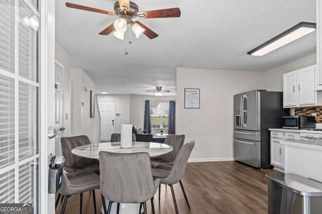 26 Springbottom Dr, Lawrenceville, GA 30046 - dining space featuring ceiling fan, dark wood-style floors, and baseboards