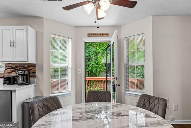 26 Springbottom Dr, Lawrenceville, GA 30046 - dining room with ceiling fan, a textured ceiling, baseboards, and wood finished floors