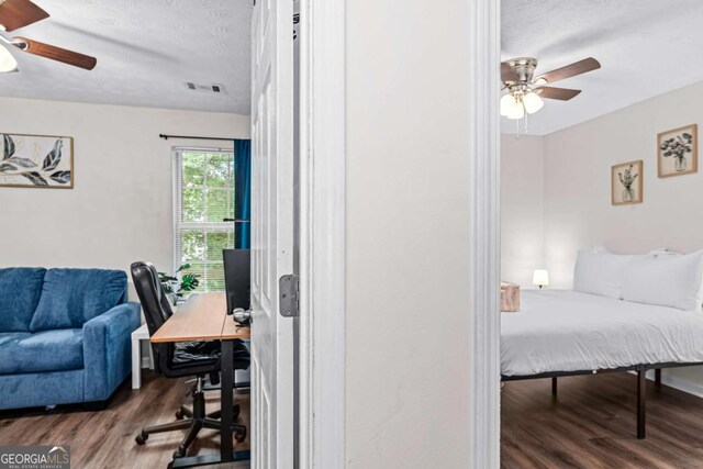 26 Springbottom Dr, Lawrenceville, GA 30046 - bedroom featuring a desk, wood finished floors, a textured ceiling, and ceiling fan