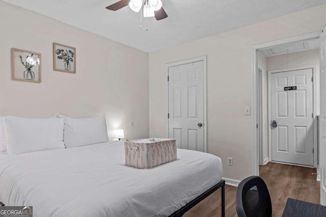 26 Springbottom Dr, Lawrenceville, GA 30046 - bedroom featuring attic access, wood finished floors, baseboards, and a ceiling fan
