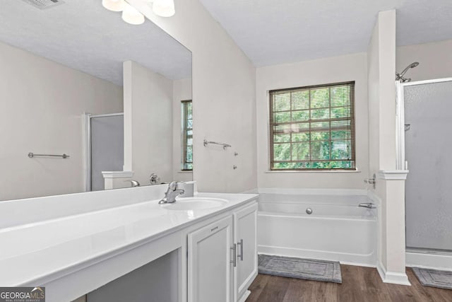 26 Springbottom Dr, Lawrenceville, GA 30046 - full bath featuring a shower stall, wood finished floors, plenty of natural light, and a textured ceiling
