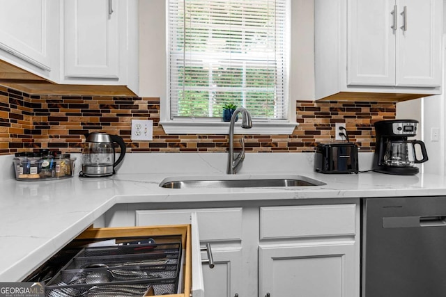 26 Springbottom Dr, Lawrenceville, GA 30046 - kitchen with stainless steel dishwasher, a sink, white cabinetry, and backsplash
