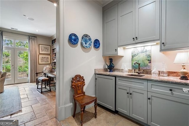 122 Old Ivy Rd NE Unit 17, Atlanta, GA 30342 - bar area featuring a sink, stone tile flooring, french doors, and crown molding