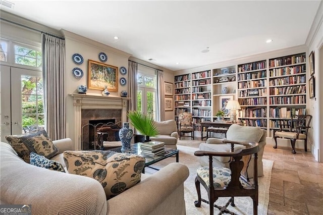 122 Old Ivy Rd NE Unit 17, Atlanta, GA 30342 - living area featuring crown molding, stone tile floors, recessed lighting, a fireplace, and built in shelves