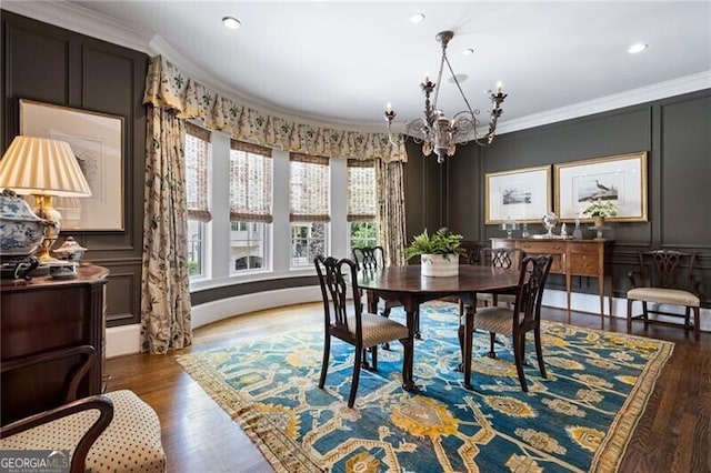 122 Old Ivy Rd NE Unit 17, Atlanta, GA 30342 - dining area with a chandelier, crown molding, wood finished floors, a decorative wall, and recessed lighting