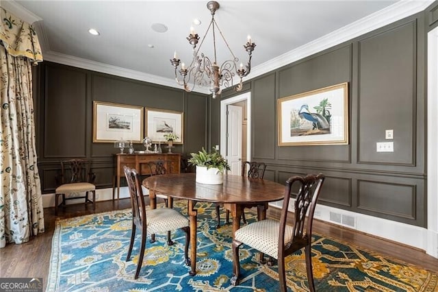 122 Old Ivy Rd NE Unit 17, Atlanta, GA 30342 - dining room featuring a decorative wall, a chandelier, wood finished floors, and crown molding