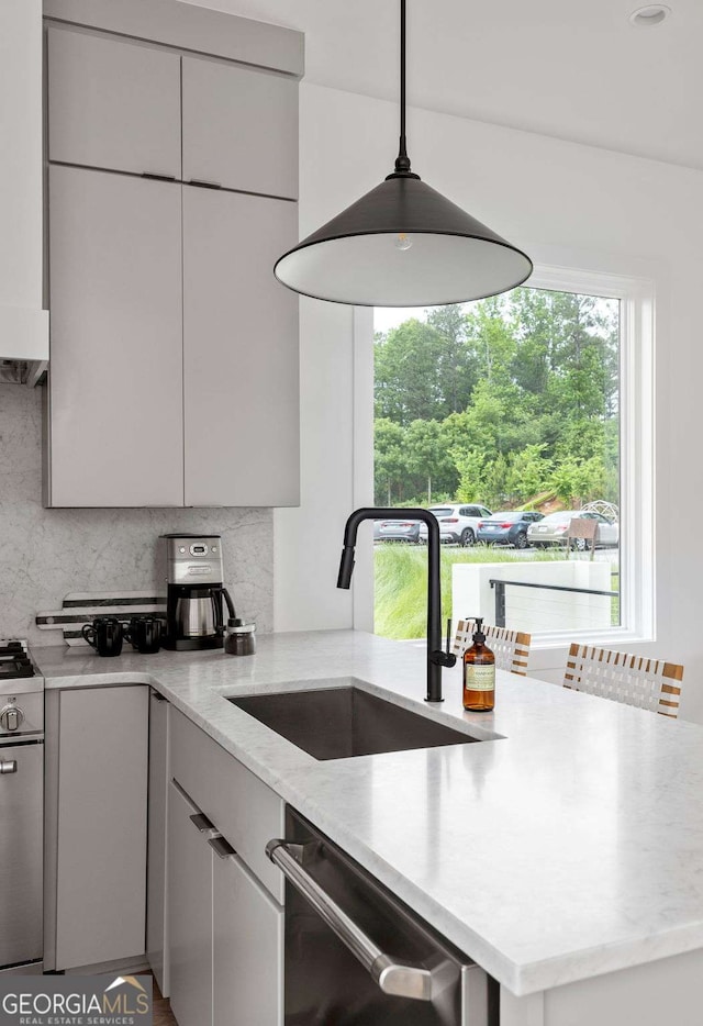 1230 Mado Loop, Chattahoochee Hills, GA 30268 - kitchen featuring a sink, stainless steel appliances, tasteful backsplash, light stone countertops, and pendant lighting