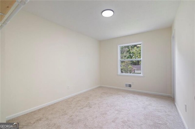 8432 Magnolia Dr, Jonesboro, GA 30238 - spare room with carpet floors and baseboards