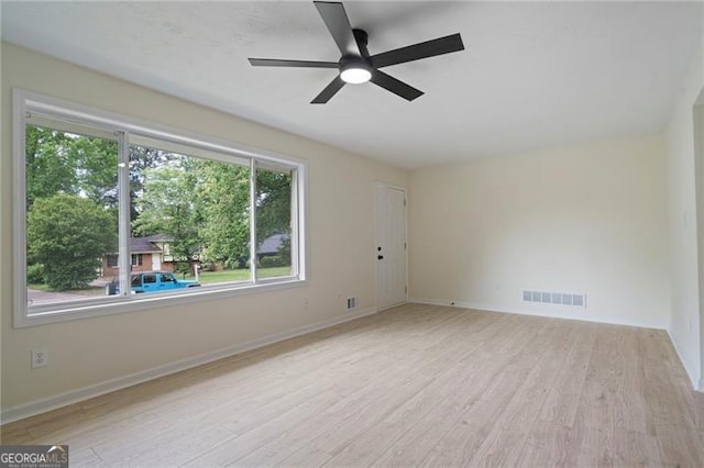 8432 Magnolia Dr, Jonesboro, GA 30238 - spare room featuring a ceiling fan, wood finished floors, and baseboards