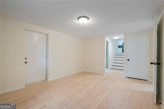 8432 Magnolia Dr, Jonesboro, GA 30238 - spare room with light wood-style floors, baseboards, and stairs