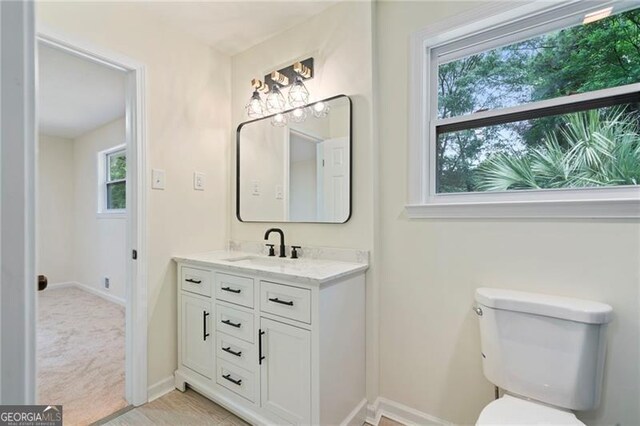 8432 Magnolia Dr, Jonesboro, GA 30238 - bathroom featuring baseboards, vanity, and toilet