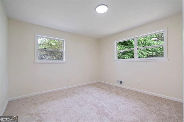 8432 Magnolia Dr, Jonesboro, GA 30238 - unfurnished room featuring plenty of natural light, carpet floors, and baseboards