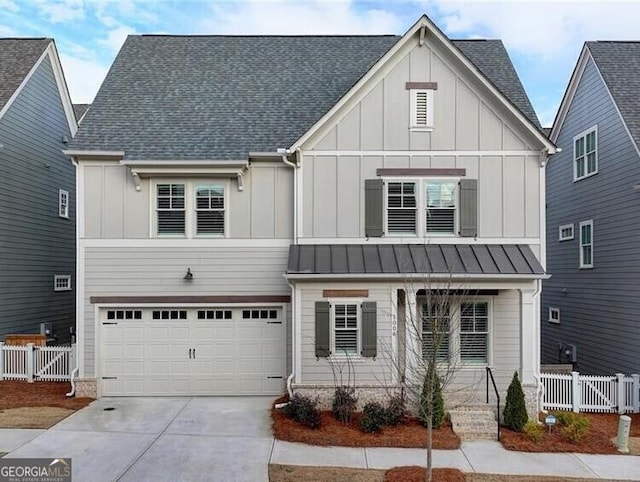 modern inspired farmhouse featuring board and batten siding, driveway, an attached garage, and fence