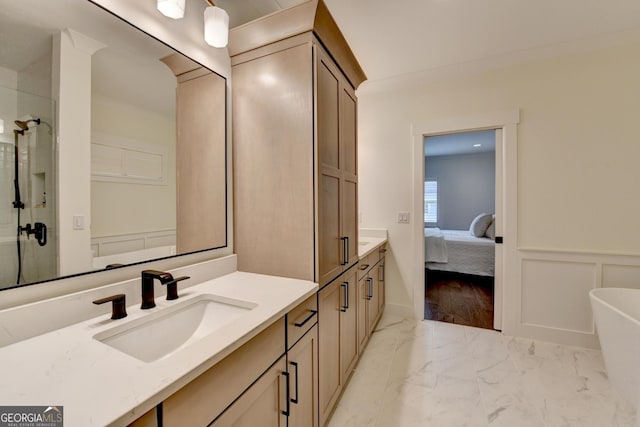 bathroom featuring marble look tile flooring, vanity, a shower stall, a freestanding bath, and wainscoting