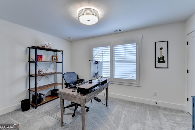 home office featuring baseboards and light carpet
