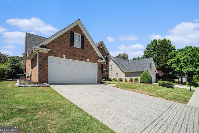 725 Windsor Place Cir SW, Grayson, GA 30017 - traditional-style home featuring driveway, brick siding, a front yard, and a garage