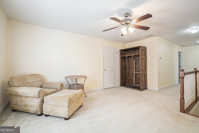725 Windsor Place Cir SW, Grayson, GA 30017 - sitting room with attic access, a ceiling fan, carpet floors, baseboards, and an upstairs landing