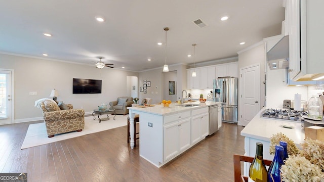 100 Maple Leaf Rd, Sharpsburg, GA 30277 - kitchen featuring appliances with stainless steel finishes, open floor plan, custom range hood, crown molding, and dark wood finished floors