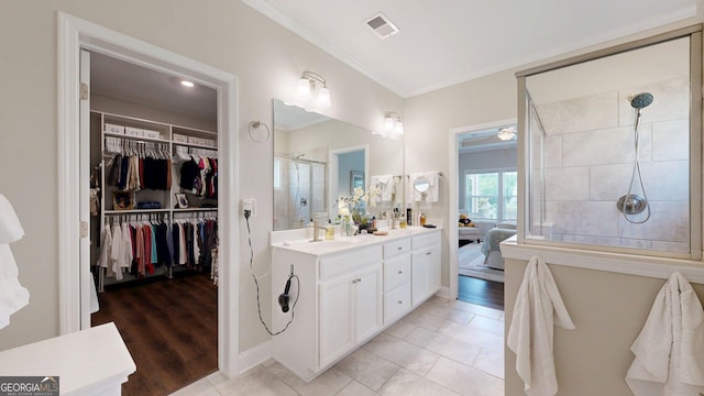 100 Maple Leaf Rd, Sharpsburg, GA 30277 - full bathroom featuring crown molding, double vanity, a shower stall, a walk in closet, and connected bathroom