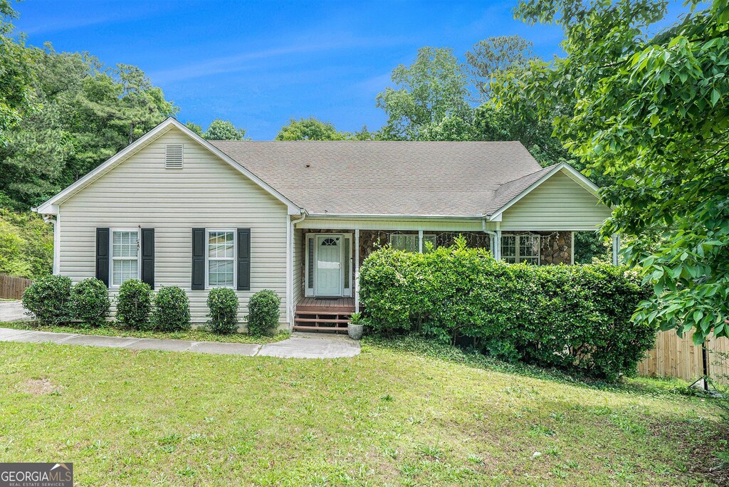 1211 Fly Rod Ln, Loganville, GA 30052 - view of front facade featuring roof with shingles and covered porch