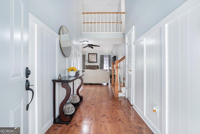 1211 Fly Rod Ln, Loganville, GA 30052 - foyer featuring wood finished floors, ceiling fan, stairway, and a towering ceiling