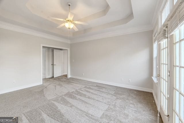 161 Pleasant Grove Rd, Mcdonough, GA 30252 - unfurnished bedroom featuring a raised ceiling, carpet floors, baseboards, crown molding, and a ceiling fan