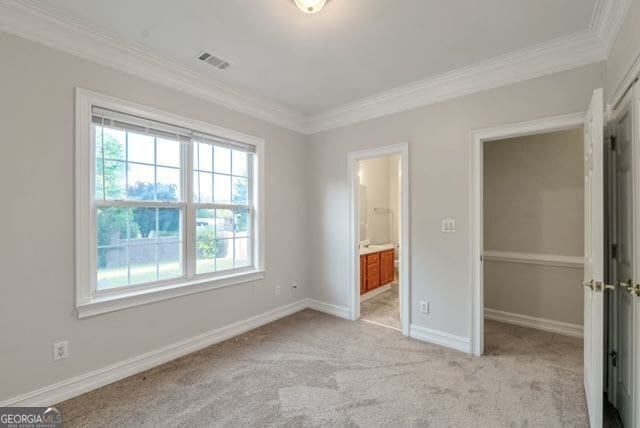 161 Pleasant Grove Rd, Mcdonough, GA 30252 - unfurnished bedroom with ornamental molding, light colored carpet, baseboards, a closet, and a walk in closet