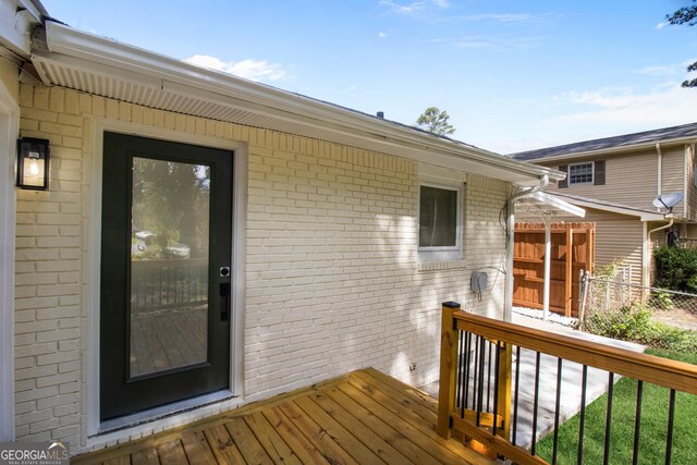 wooden terrace featuring fence