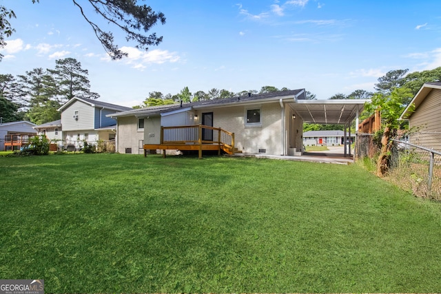 rear view of property with an attached carport, a wooden deck, brick siding, and crawl space