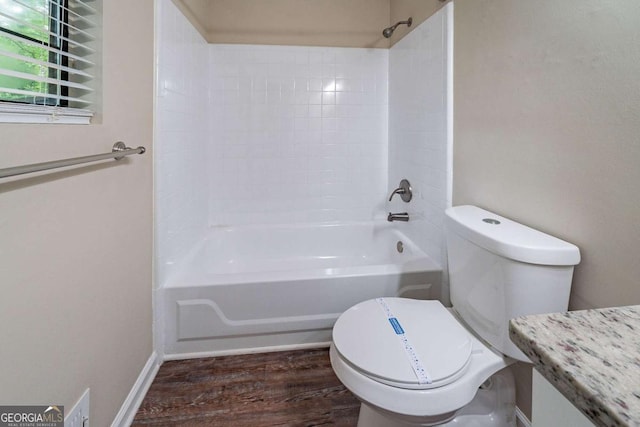 full bathroom featuring wood finished floors, toilet, and shower / bathtub combination