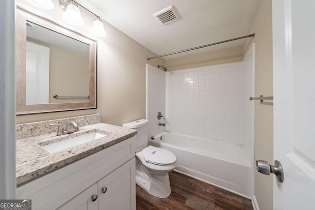 full bath featuring wood finished floors, toilet, vanity, and  shower combination