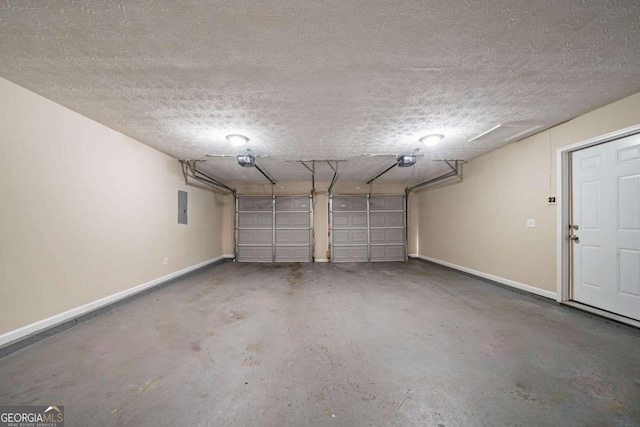 garage with baseboards, a garage door opener, and electric panel