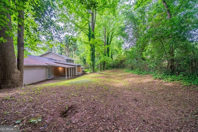 view of yard featuring a wooded view