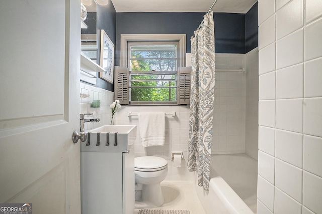 4128 Morgan Rd, Tucker, GA 30084 - bathroom featuring tile walls, vanity, and shower / bathtub combination with curtain