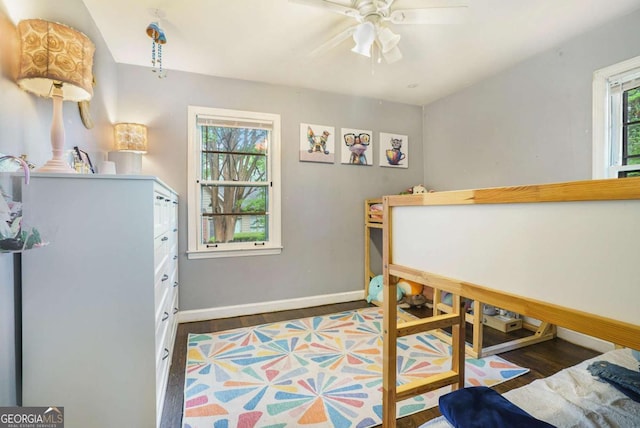 bedroom featuring wood finished floors, baseboards, and a ceiling fan